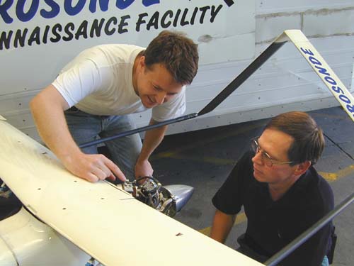 Ray Cooper, Monash University's UA pilot, gets a briefing from Gavin Brett, Lead Development Engineer for Aerosonde Ltd